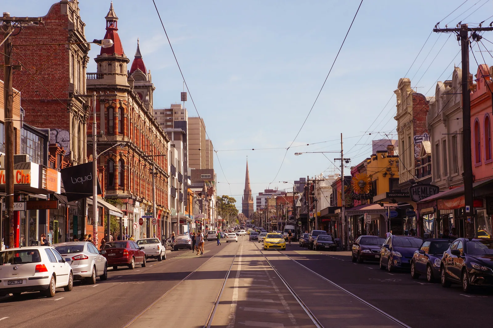 Shopfronts and painted walls along a street in Fitzroy, Melbourne